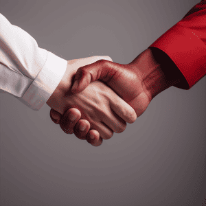 Two business people shaking hands on a gray background.